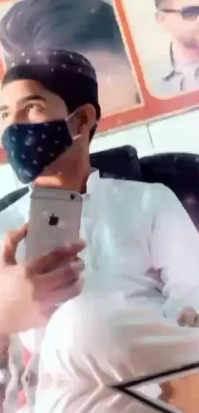 Man in black cap with iPhone in hand wearing a mask.