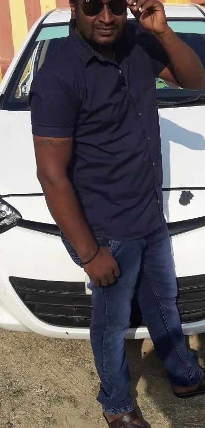 Stylish man standing beside a white car, showcasing urban fashion.