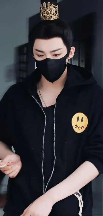 A masked individual with a crown in a stylish black hoodie.