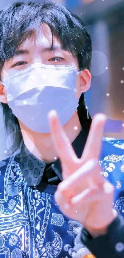 Masked person with peace sign in a stylish, blue-themed portrait.