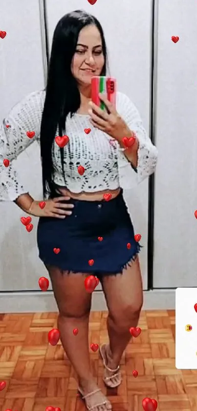 Woman taking a stylish mirror selfie in fashionable attire.