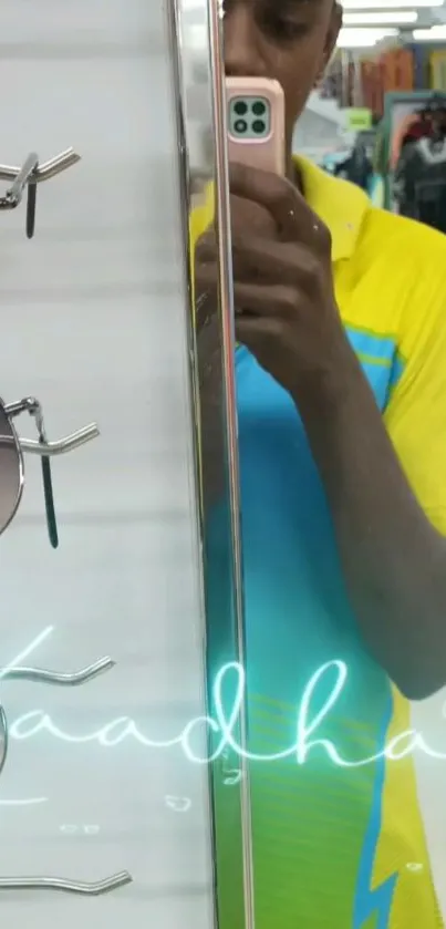 Mirror selfie with fashion and sunglasses display, vibrant yellow theme.