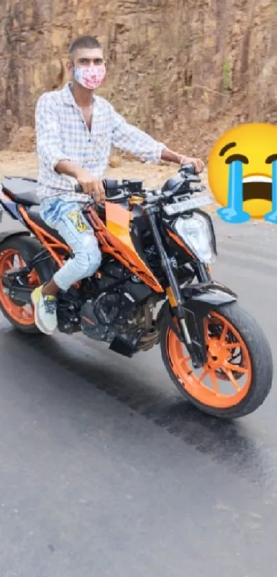 Man riding a stylish orange motorcycle on a scenic road.