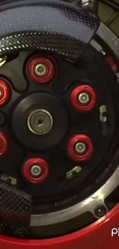 Detailed motorcycle wheel with red accents and black background.