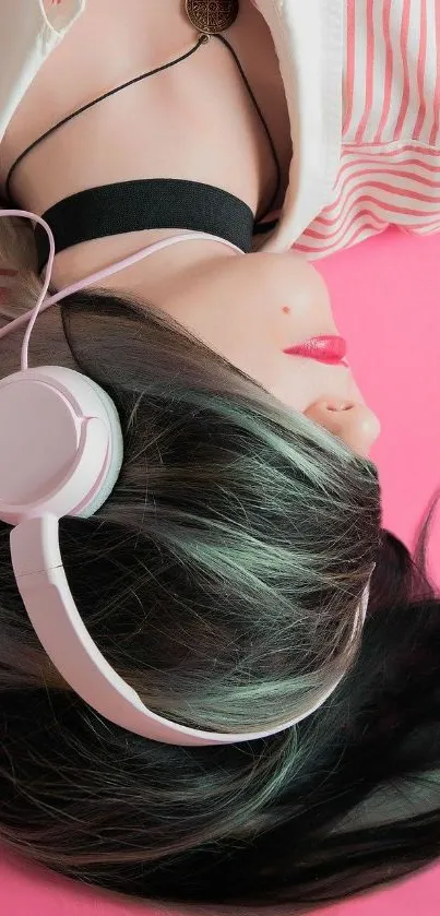 Woman with pink headphones on a pink background.