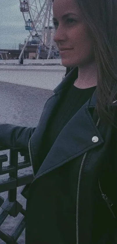 Stylish woman in a leather jacket by the cityscape at night.