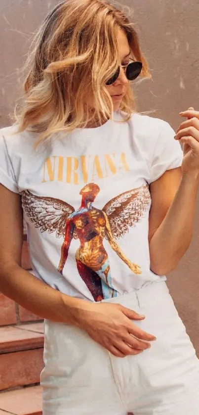 Woman in a Nirvana T-shirt with artistic design on stairs.