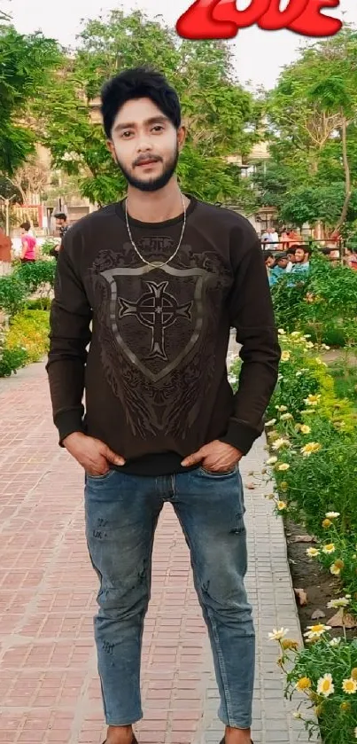 Casual young man posing outdoors in green scenic park.