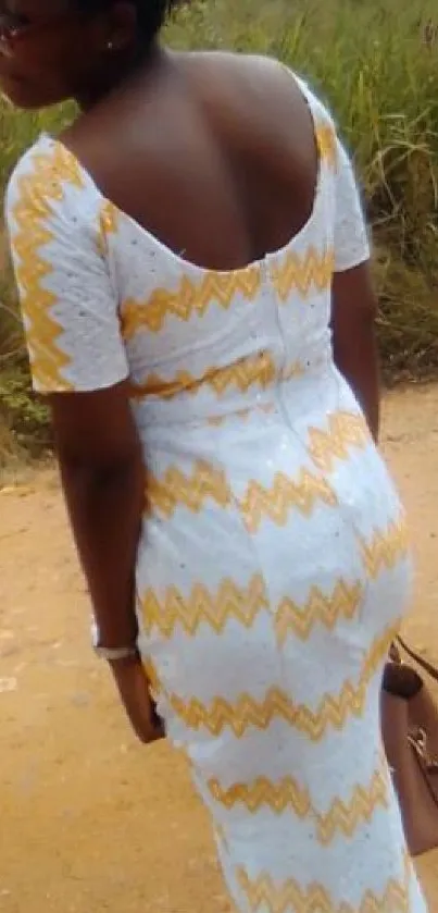 Back view of a woman in a zigzag pattern dress, outdoor setting.