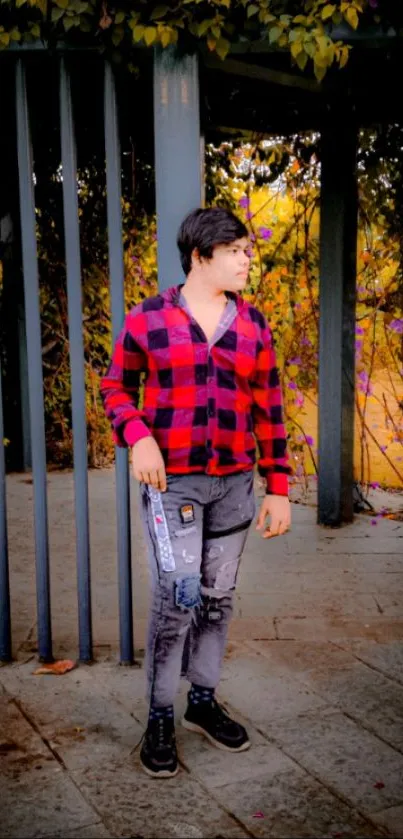 Person in red plaid shirt standing outdoors with natural background.