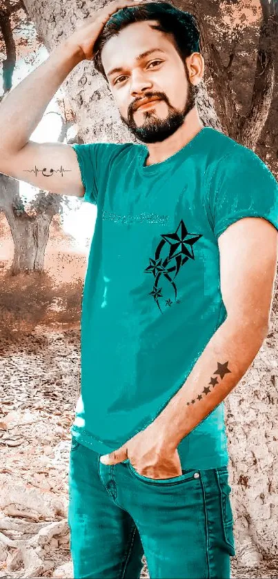 Stylish tattooed man in a teal shirt outdoors.