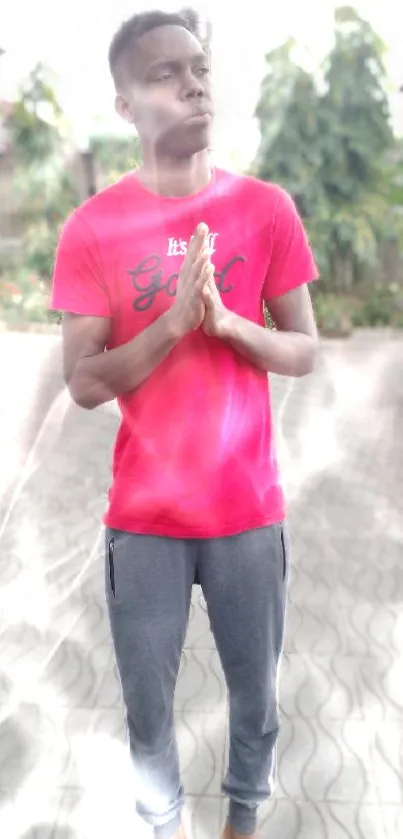 Young person in red shirt outdoors.
