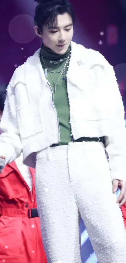 Fashionable person in stylish white outfit onstage.