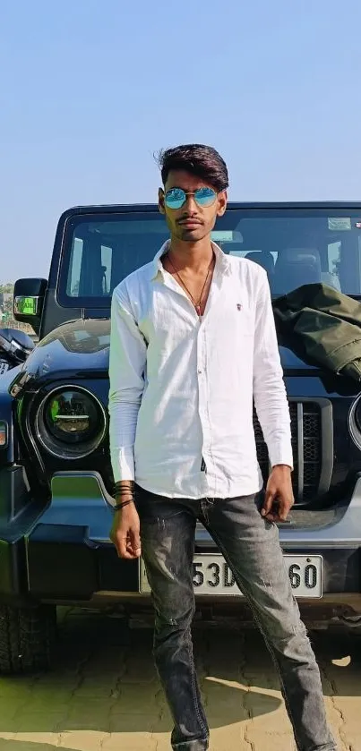 Man in sunglasses with black SUV in background, showcasing urban style.