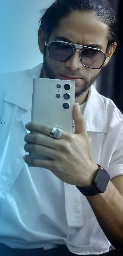 Man taking a mirrored selfie with stylish fashion and a sleek mobile phone.