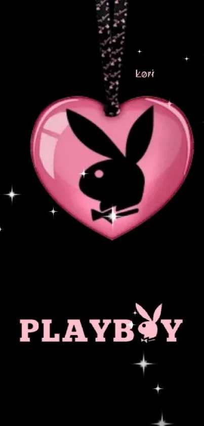 Pink heart with bold emblem on black background wallpaper.