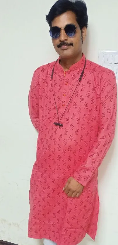 Person wearing a stylish pink kurta with white pants