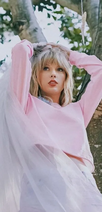 Person in elegant pink outfit with green background.