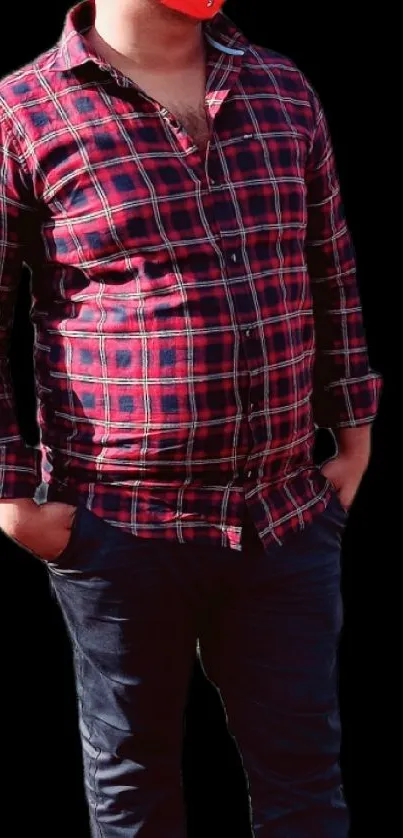 Man in red plaid shirt on a black background.