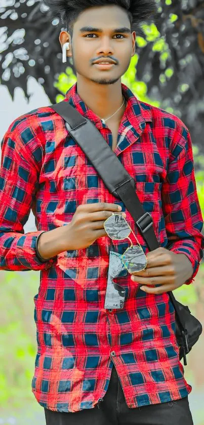 Stylish portrait with red plaid shirt and accessories.