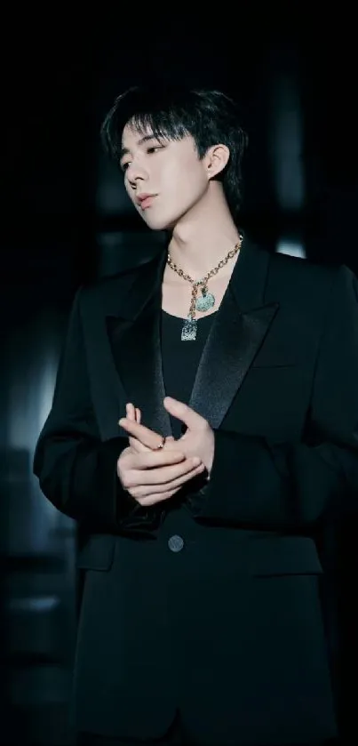 Stylish young man in a dark suit with moody background wallpaper.