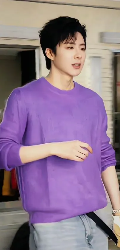 Person wearing purple sweater with urban background.