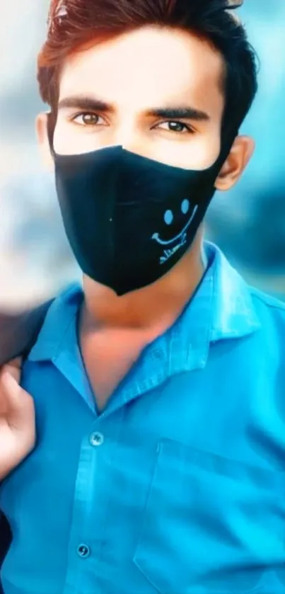 Person wearing a stylish black mask, blue shirt, artistic look.