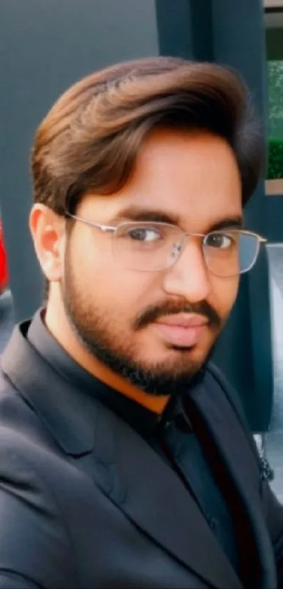 Professional man with glasses in a suit outdoors.