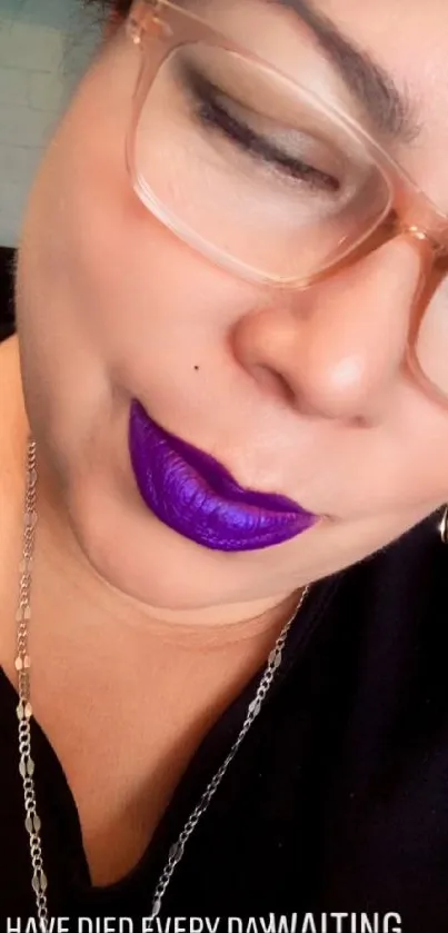 Person with bold purple lipstick and glasses.