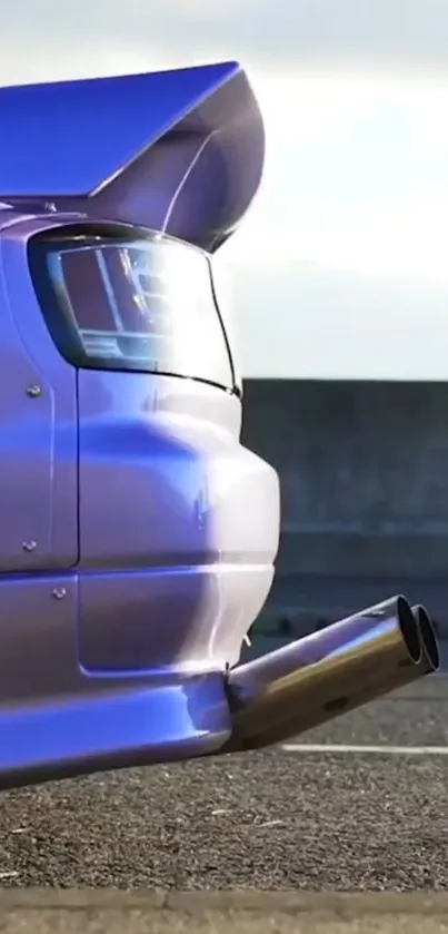 Purple sports car tail with dual exhaust on a road.