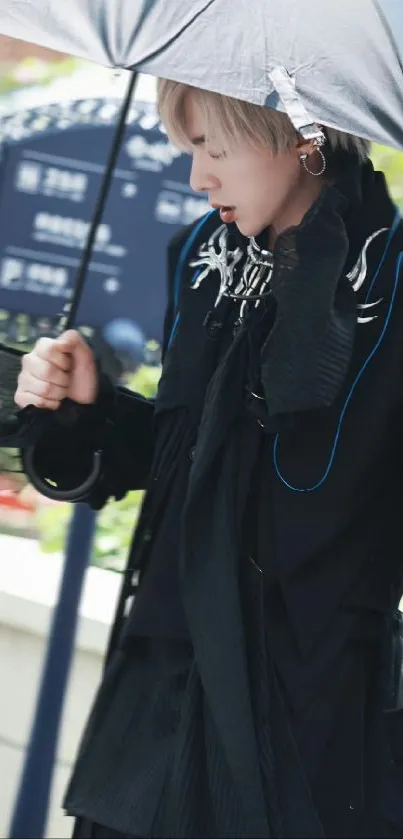 Stylish person under an umbrella in rain.