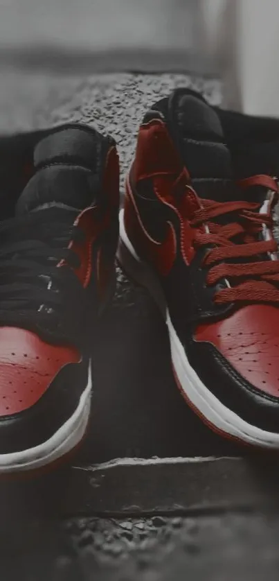 Red and black sneakers on steps with blurred background.