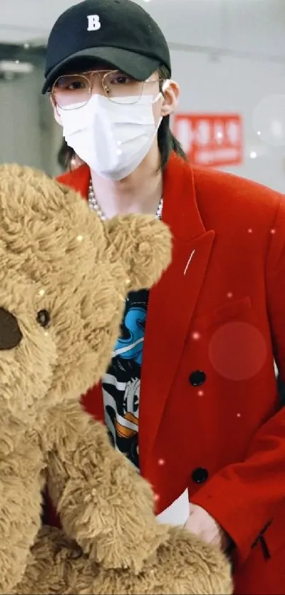 Person in a red coat holding a teddy bear, ideal for wallpaper.