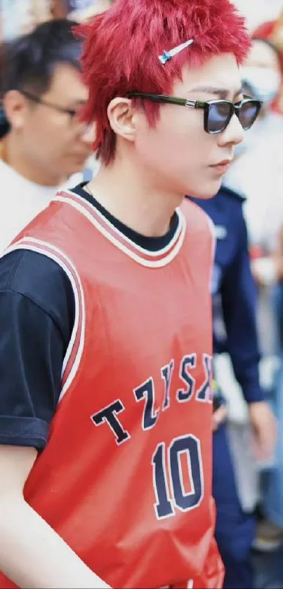 Red-haired person in basketball jersey at an event.