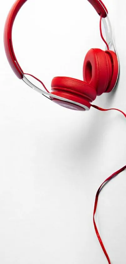 Red headphones on a white minimalist background.