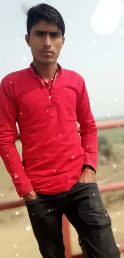 Young man in red shirt with scenic background.