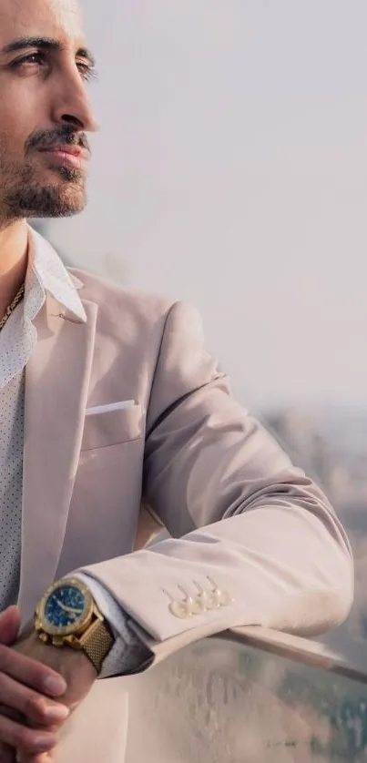 Man in beige suit with city skyline background.