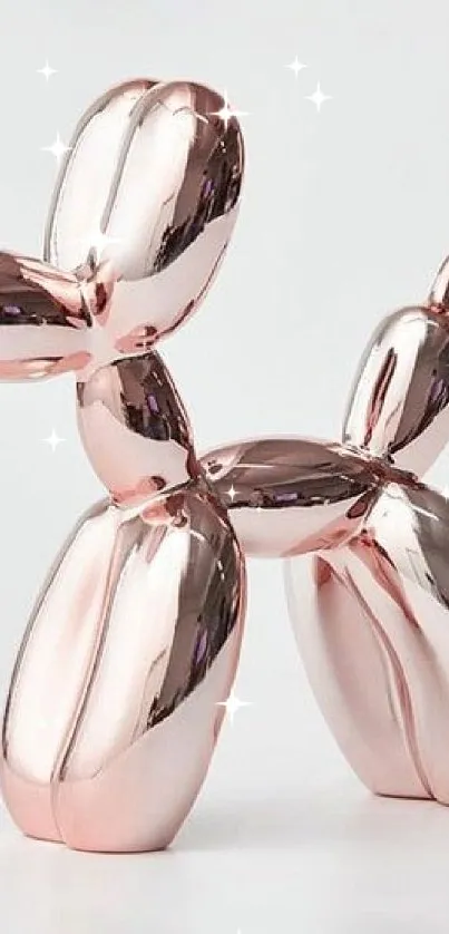 Rose gold balloon dog sculpture on white background.