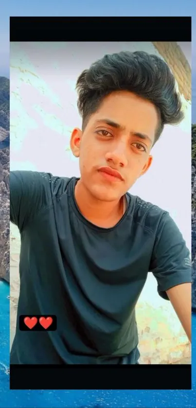 Stylish young man taking a selfie by the beach with a stunning coastal view.