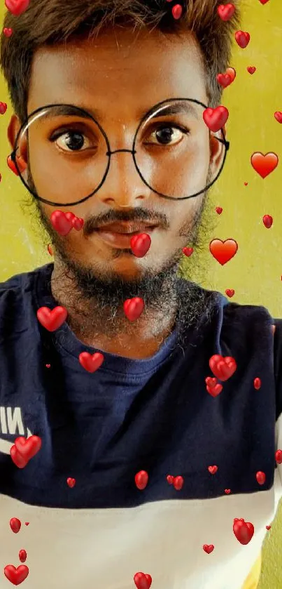 Stylish selfie with glasses and heart design on green background.