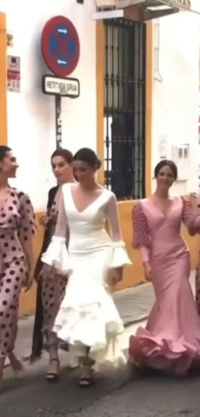 Elegant women in stylish dresses walking in Seville street.