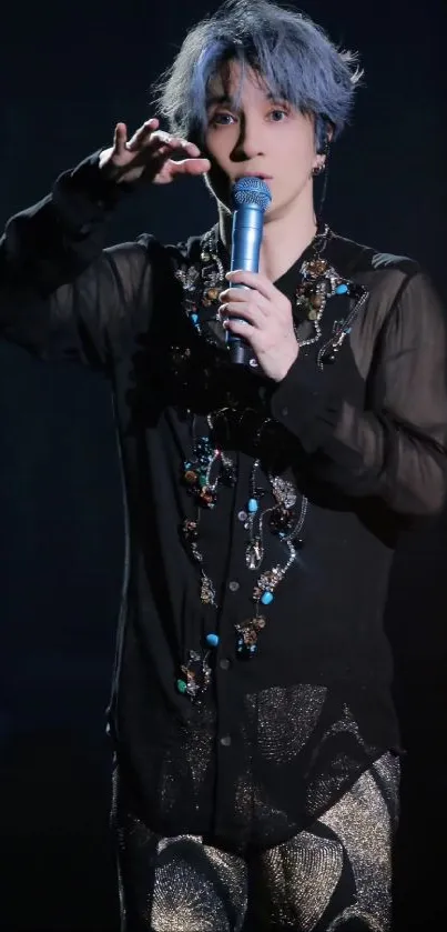 Singer in black outfit performing on stage.