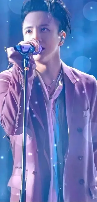 Singer in lavender coat performing on stage.