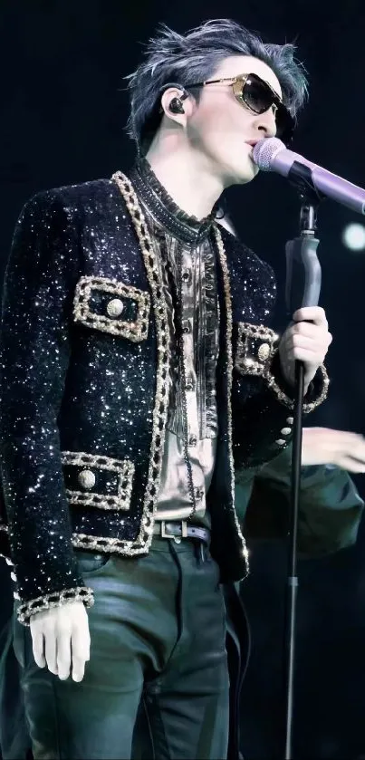 Singer in sparkling jacket performing on stage.