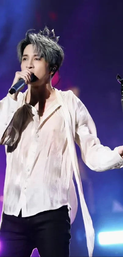 Singer on stage with vibrant purple lights during a live concert.