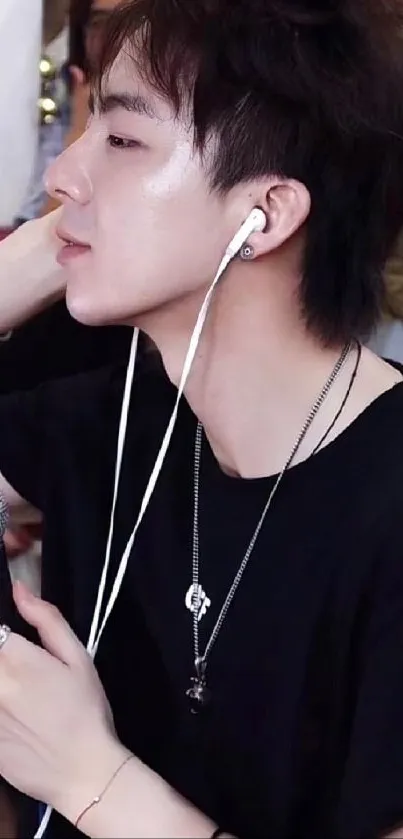 Singer in black shirt with headphones and a microphone.