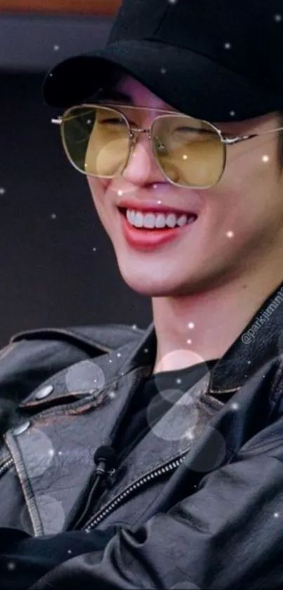 Smiling person with sunglasses and leather jacket wallpaper.