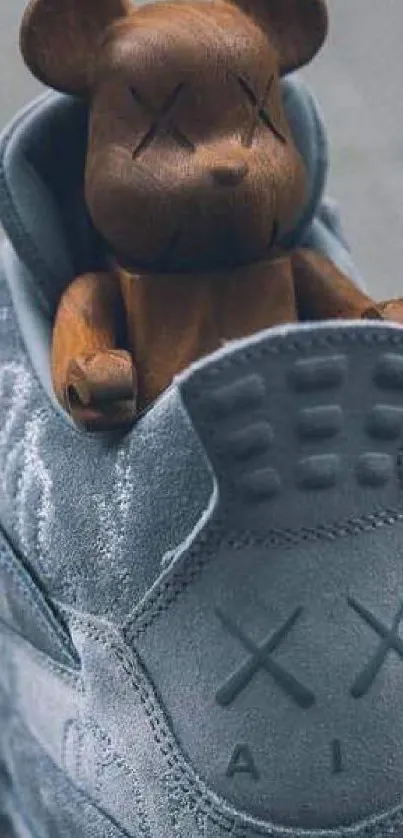 Wooden bear sitting inside grey sneaker.