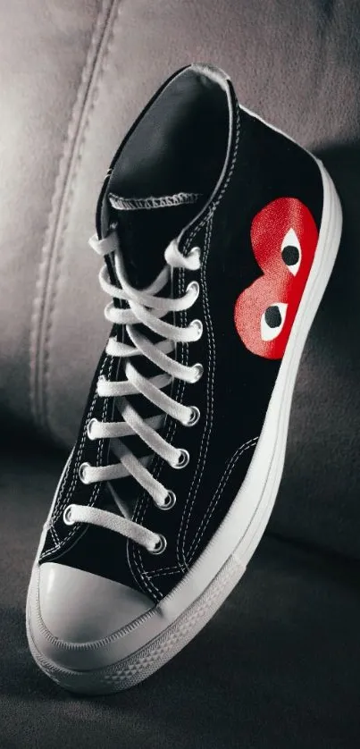 Black high-top sneaker with red eyes design.