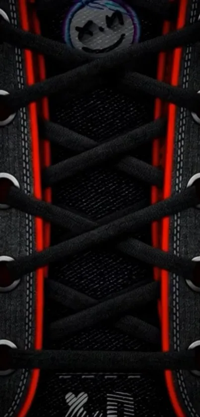 Black sneaker laces with red highlights on wallpaper.